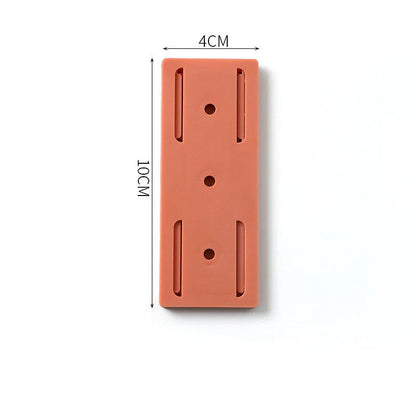 Self-adhesive wall hook in green, blue, white, and pink for cable organisation