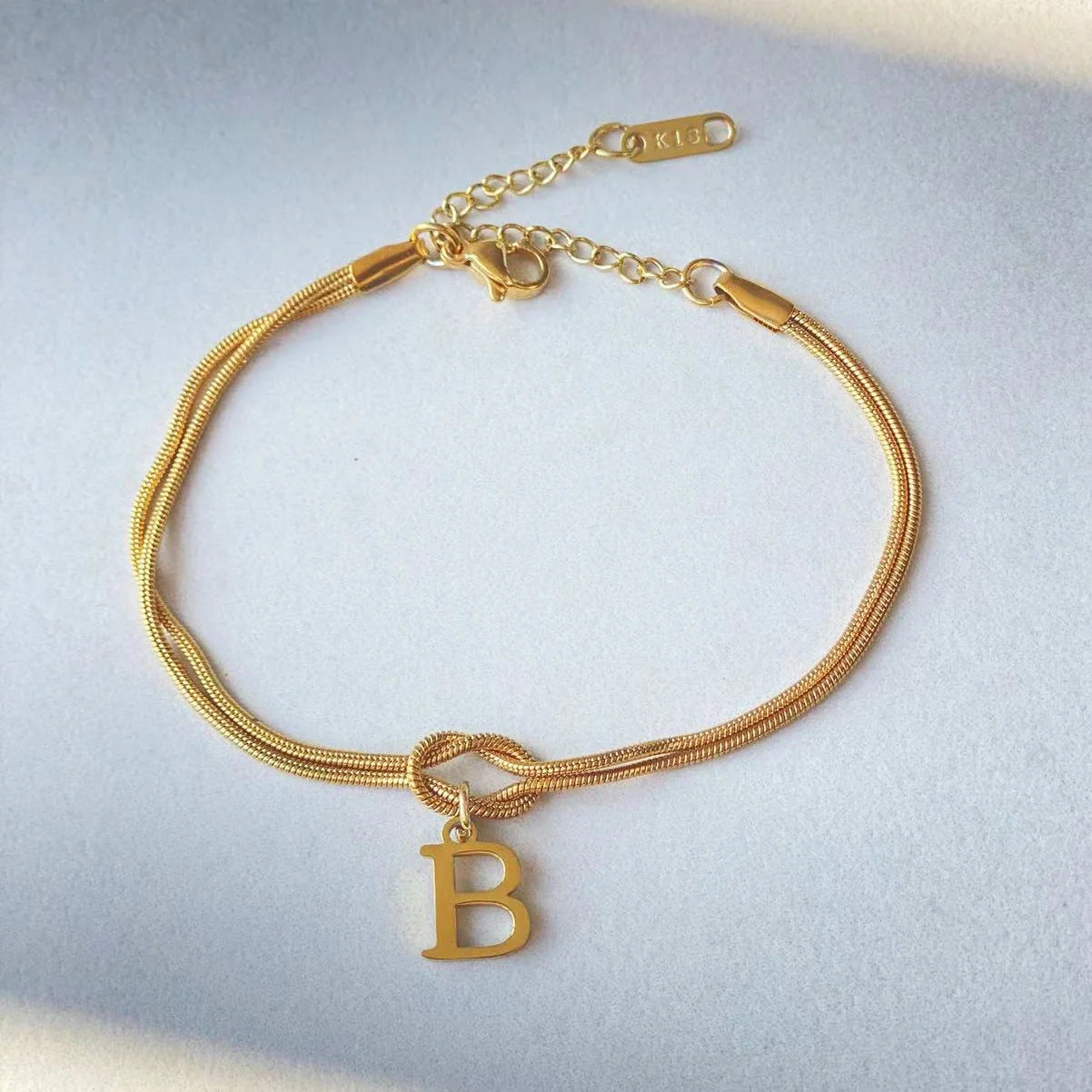 Personalised gold and silver love knot bracelets for couples, perfect as Valentine's Day gifts.