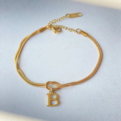 Personalised gold and silver love knot bracelets for couples, perfect as Valentine's Day gifts.