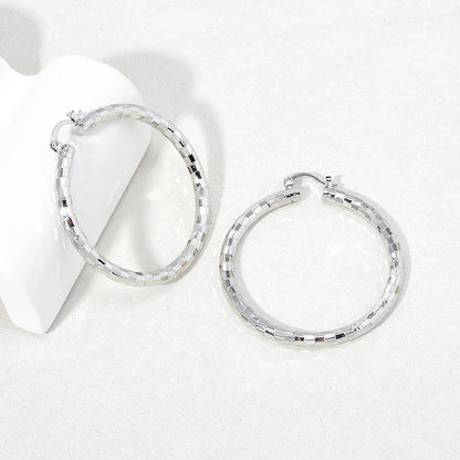 Elegant gold-plated minimalist circular earrings with a sophisticated British design