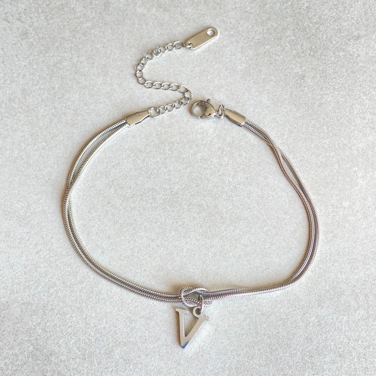 Personalised gold and silver love knot bracelets for couples, perfect as Valentine's Day gifts.