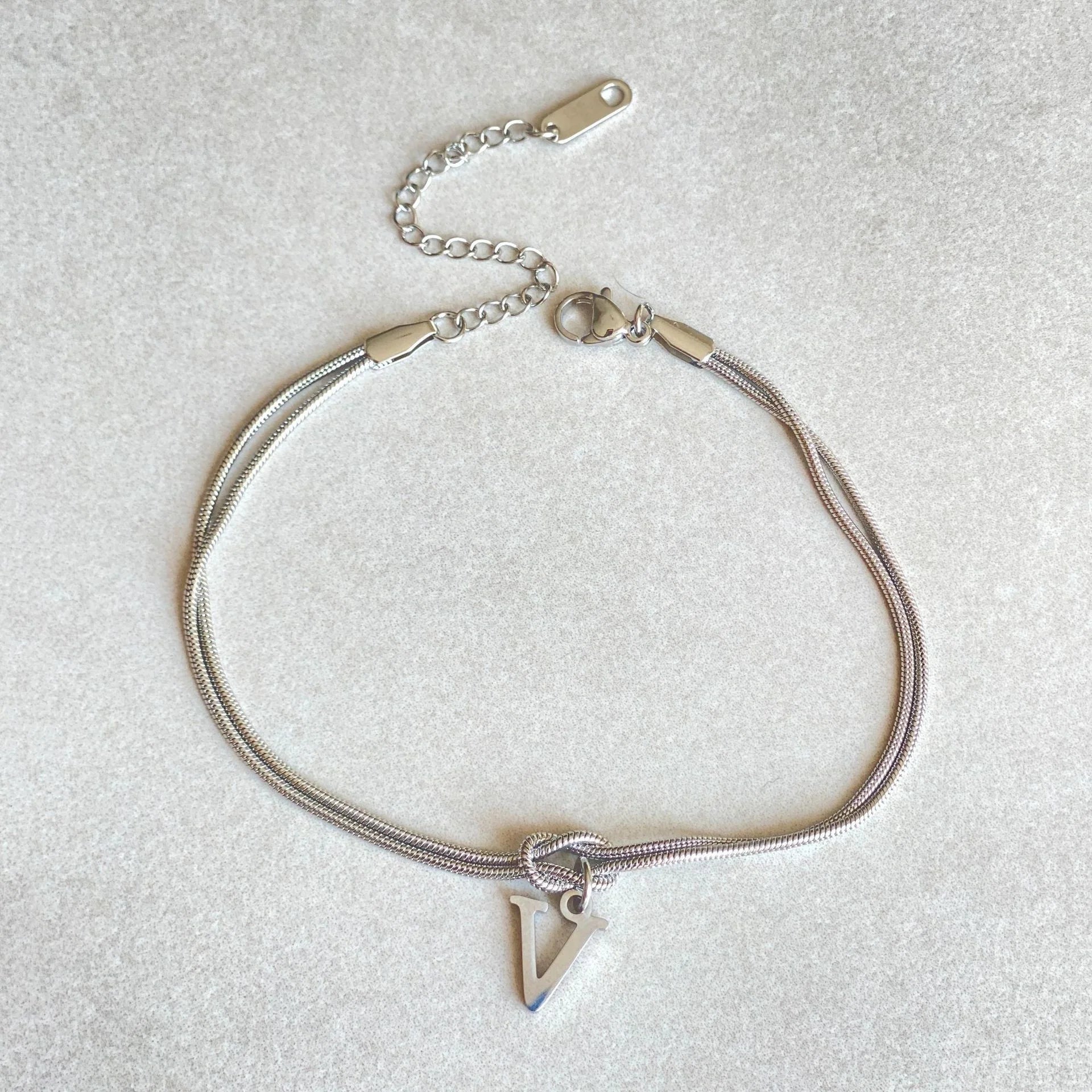 Personalised gold and silver love knot bracelets for couples, perfect as Valentine's Day gifts.