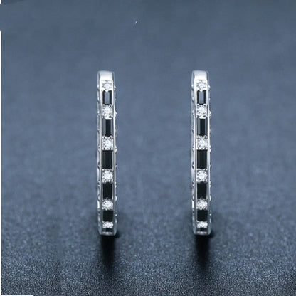A pair of elegant black zircon earrings with a round, geometric design made of premium copper