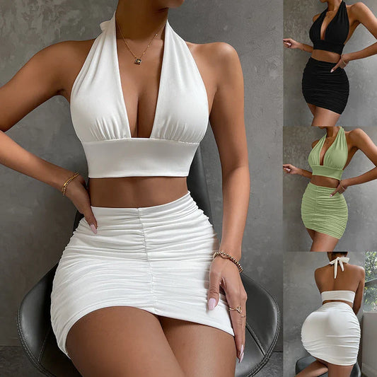 A stylish two-piece dress set featuring a halter-style lace-up top and a pleated hip-covering skirt, available in white, black, and pea green colors.
