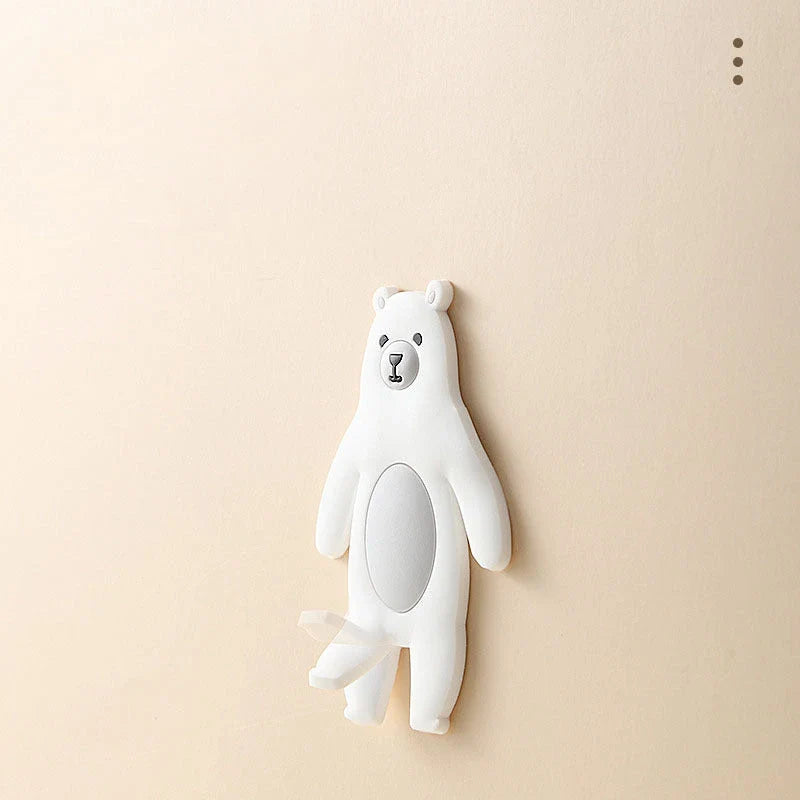 Assorted animal-shaped wall hooks in various colours, including bear, zebra, and cow designs, displayed on a white background