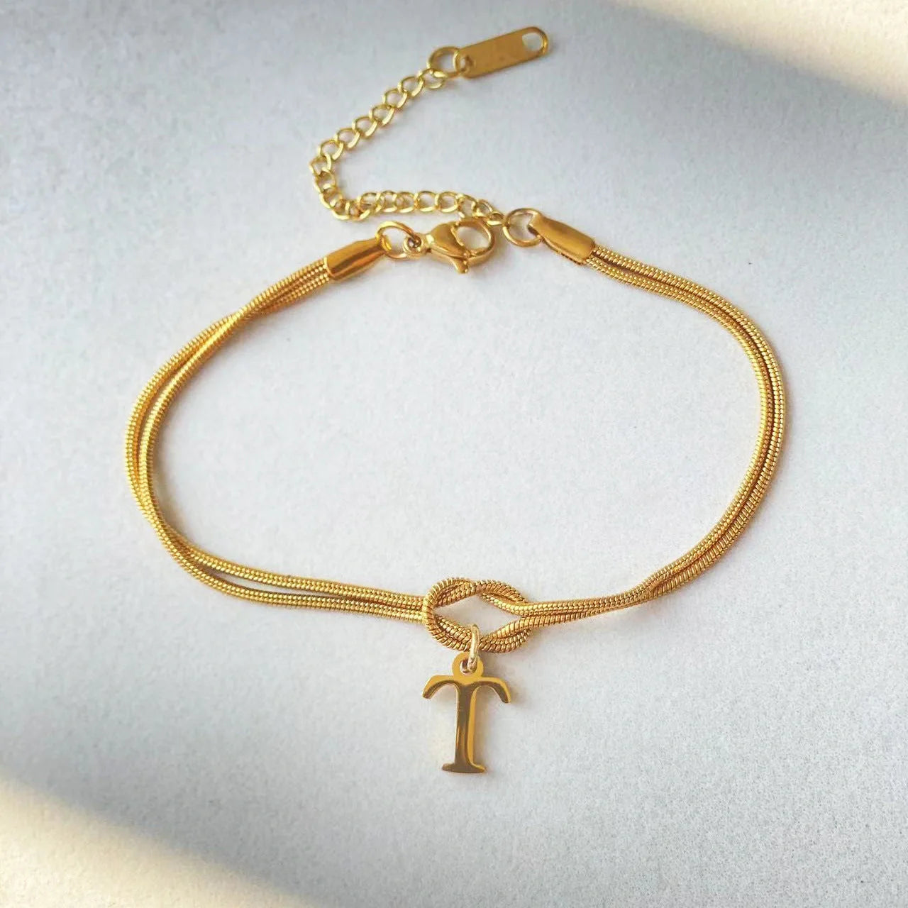 Personalised gold and silver love knot bracelets for couples, perfect as Valentine's Day gifts.