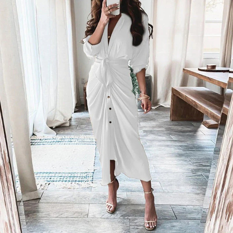 A beautiful floral wrap dress with lace-up detailing, featuring a deep V-neck and full-length skirt for a flattering, elegant look.