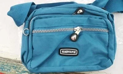 Small square messenger bag in water-repellent nylon with multi-compartment design