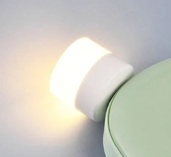 Compact USB LED night light with soft glow for reading and sleep