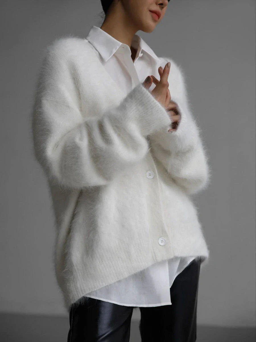 A stylish loose knit cardigan in a variety of colors, featuring a v-neck design and single-breasted closure for a flattering, relaxed fit.
