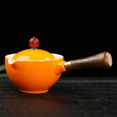 Handcrafted ceramic teapot with wooden handle, designed for brewing traditional Oolong tea with enhanced flavour and aroma