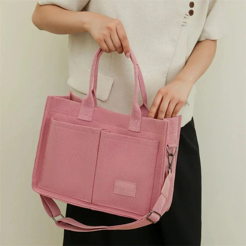 Stylish and durable canvas tote bag with multiple pockets for everyday use