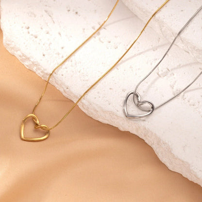 Titanium steel heart pendant necklace in gold and silver finishes, featuring an elegant and adjustable design for a customized fit