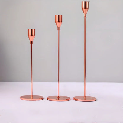 Elegant European metal candle holders in various colours, including gold, silver, and black, providing a warm and inviting ambience to any living space.