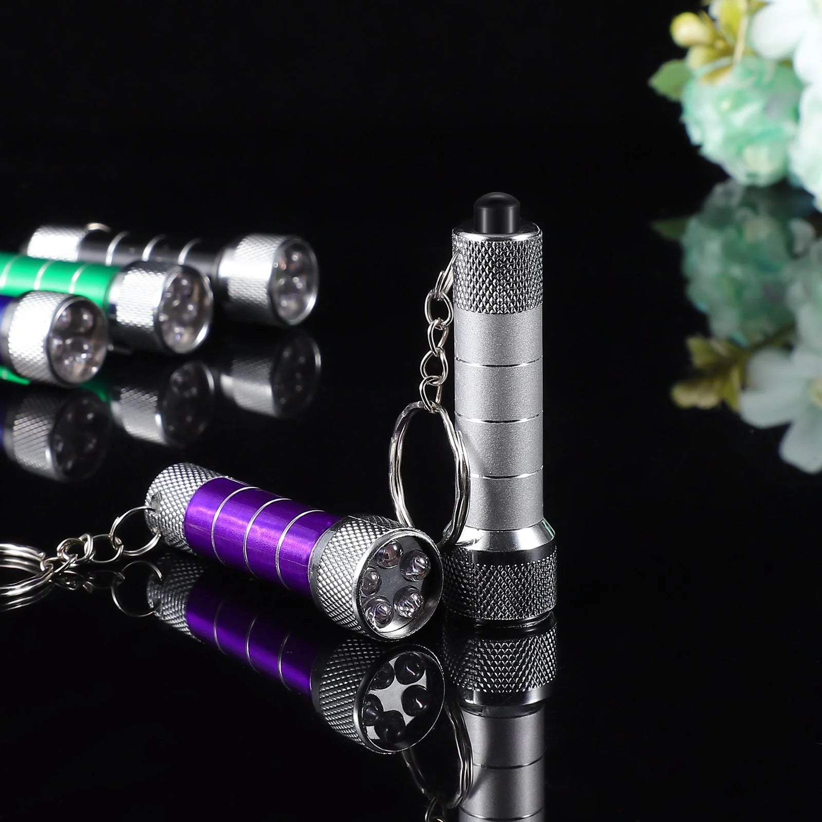 Compact LED keychain torch in four colours for emergencies and camping