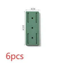 Self-adhesive wall hook in green, blue, white, and pink for cable organisation