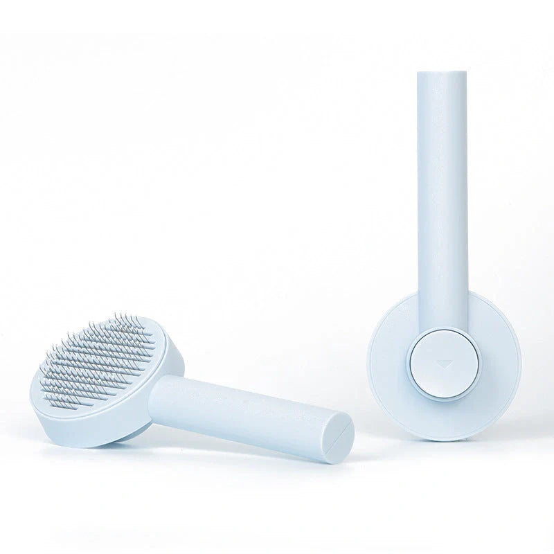 Self-cleaning pet grooming comb with stainless steel needles in blue, pink, and white