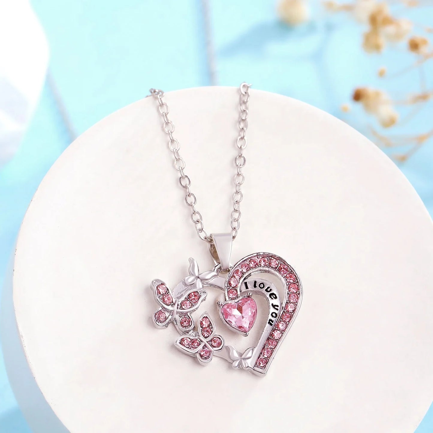 Butterfly Love Necklace with rhinestones and hollow heart-shaped pendant in white, purple, or pink