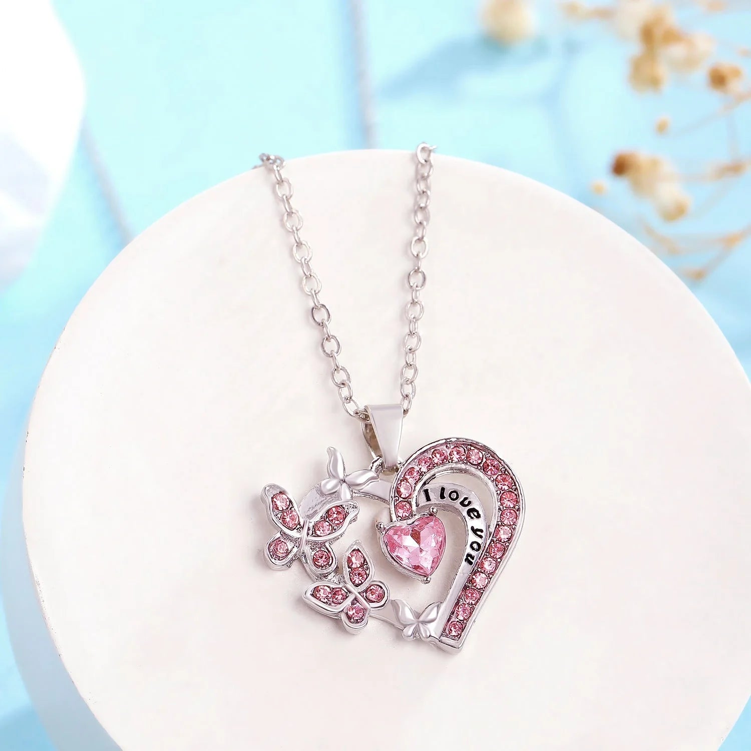 Butterfly Love Necklace with rhinestones and hollow heart-shaped pendant in white, purple, or pink