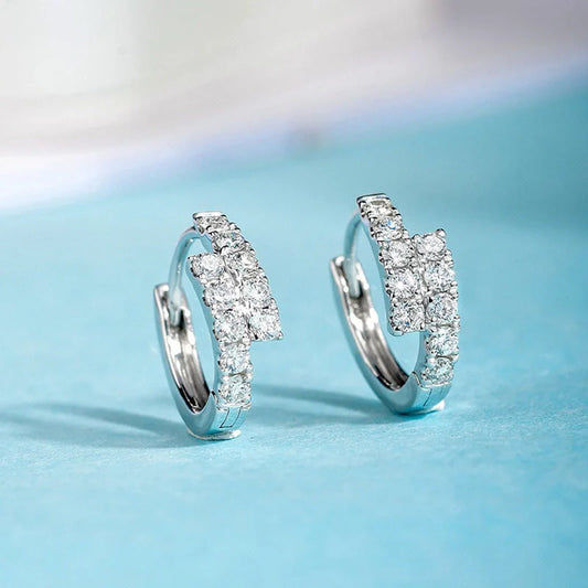 Elegant diamond-accented ear clips with a geometric design, showcasing refined British style.