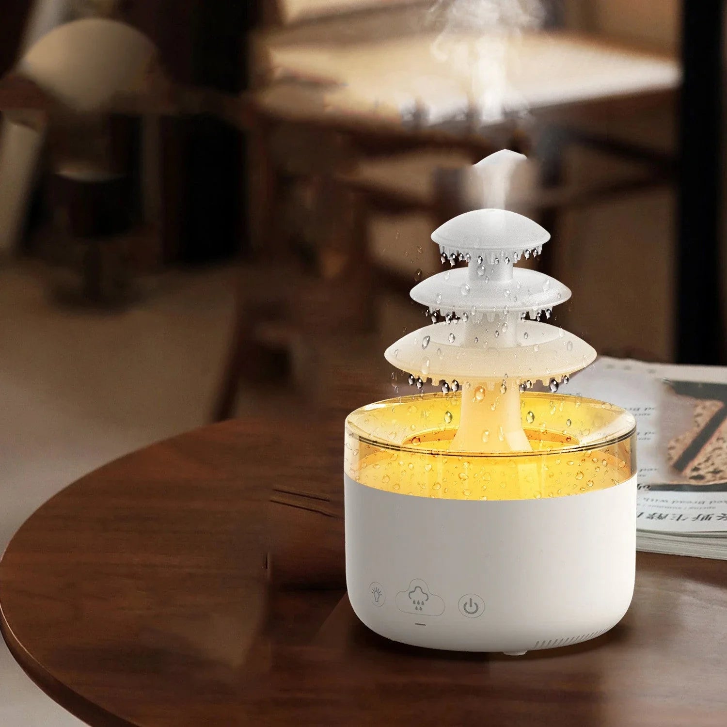 A white humidifier with a cloud-shaped design, featuring color-changing lights and essential oil diffuser capabilities.