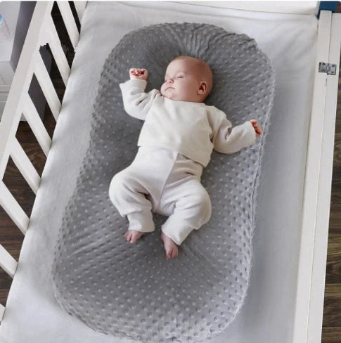 Newborn bionic nap bed in blue and yellow, designed for safety and comfort