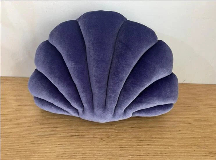 Cosy shell-shaped plush nap pillow in various colours and sizes for ultimate comfort