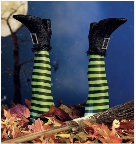 Halloween witch leg decorations with striped stockings and black boots