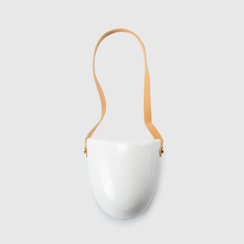 Wall-mounted ceramic flower pot in matte white with hemp rope for balcony gardening
