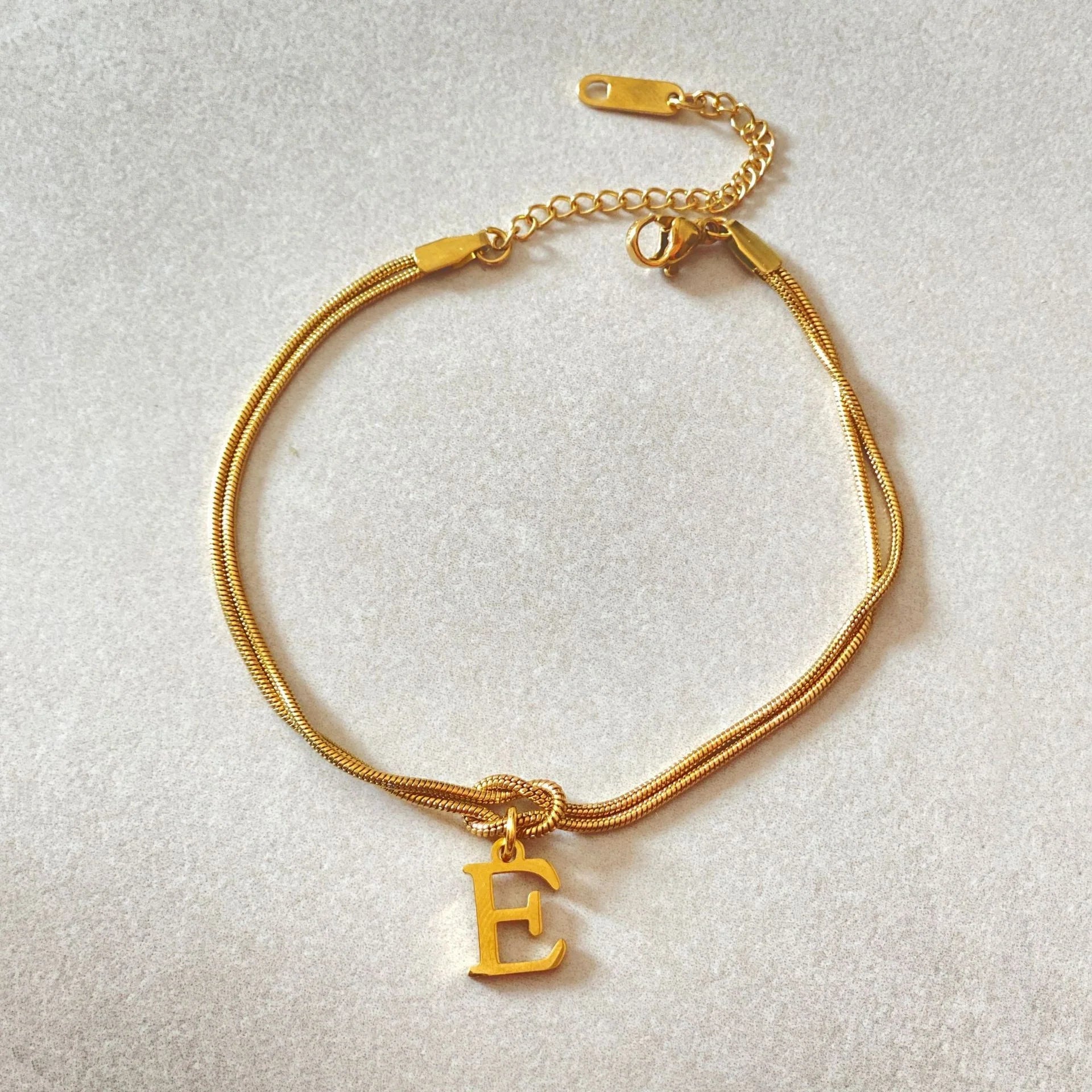 Personalised gold and silver love knot bracelets for couples, perfect as Valentine's Day gifts.