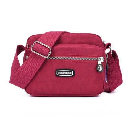 Small square messenger bag in water-repellent nylon with multi-compartment design