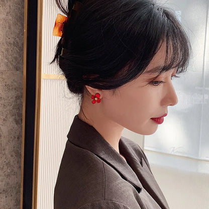 Elegant silver earrings with delicate red petal design inspired by Korean fashion