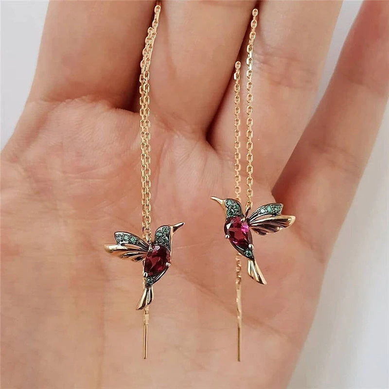 Elegant hummingbird drop earrings with crystal accents, a versatile fashion accessory for British women