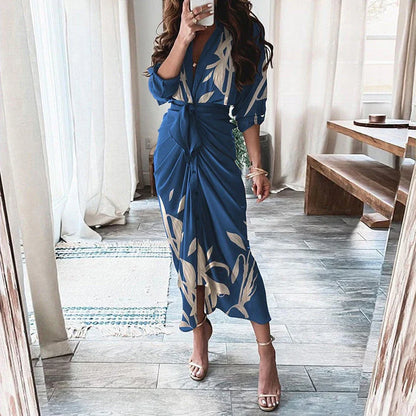A beautiful floral wrap dress with lace-up detailing, featuring a deep V-neck and full-length skirt for a flattering, elegant look.