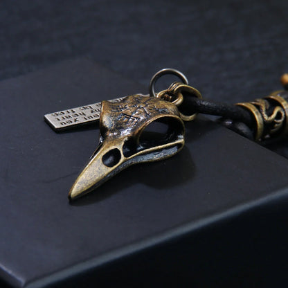 Retro leather keychain with lobster clasp and skull motif in bronze and silver