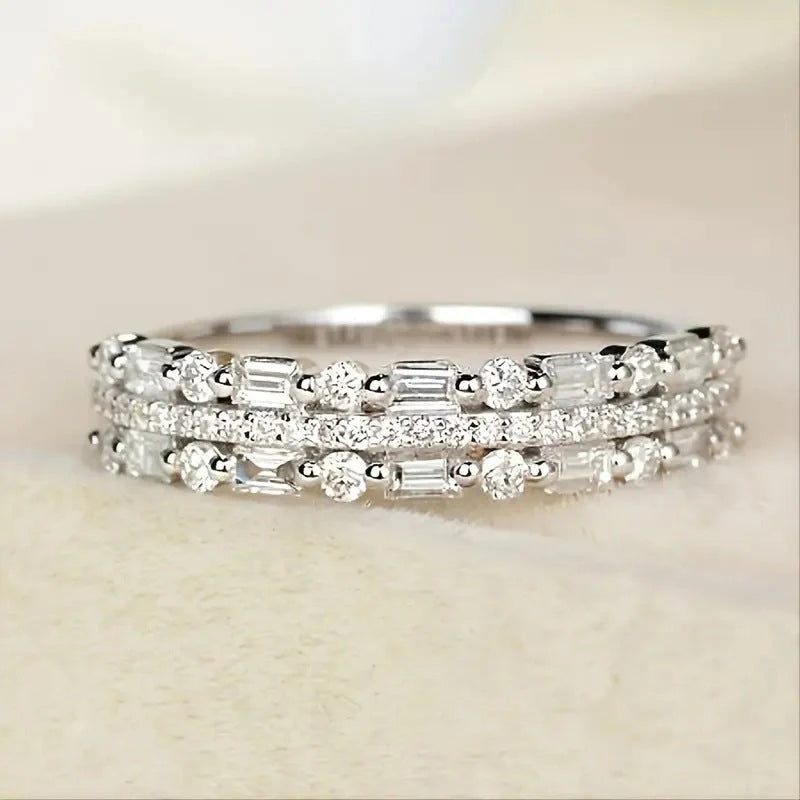 Elegant multilayer ring with a subtle geometric design, available in platinum, gold, and rose gold colours