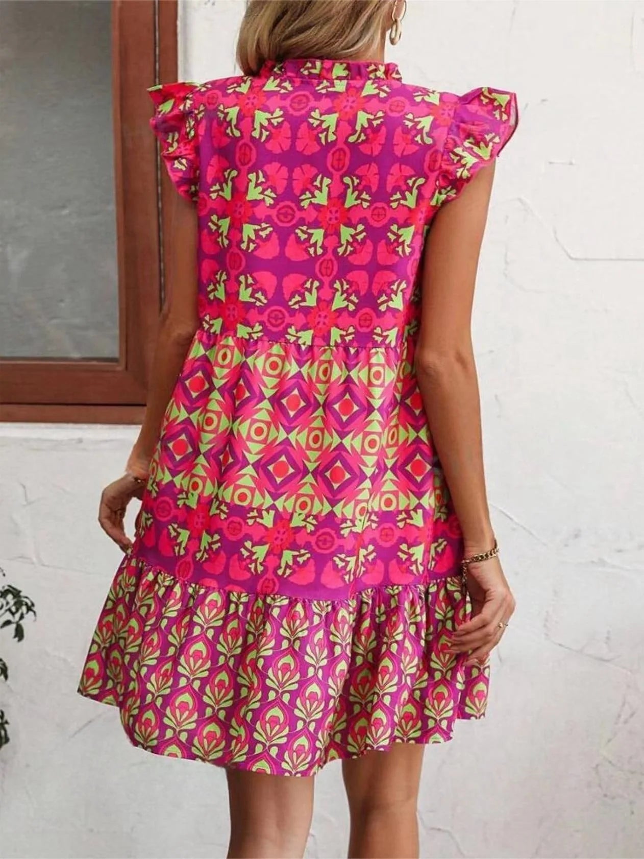 Stylish sleeveless dress with v-neck, lace-up detailing, and vibrant digital printing for a chic summer look