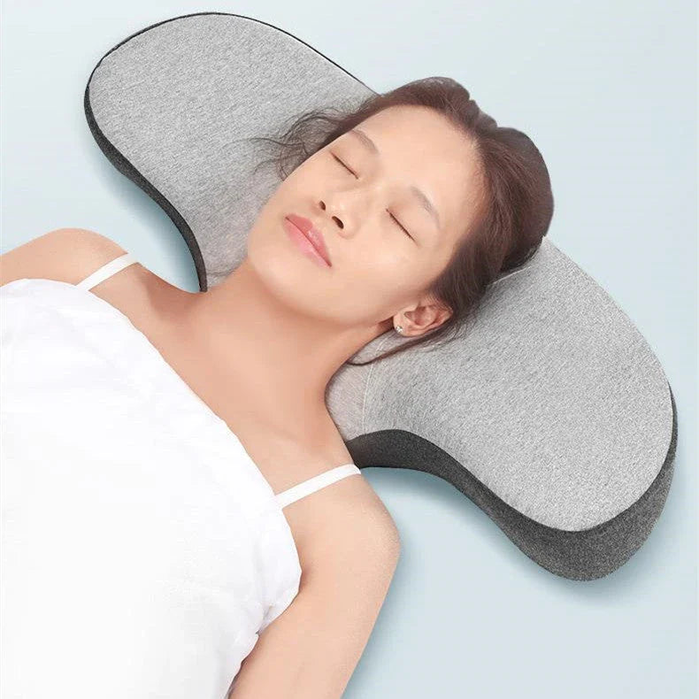 Cozy contoured memory foam pillow with gray cover, providing optimal neck support and comfort for a restful night's sleep.