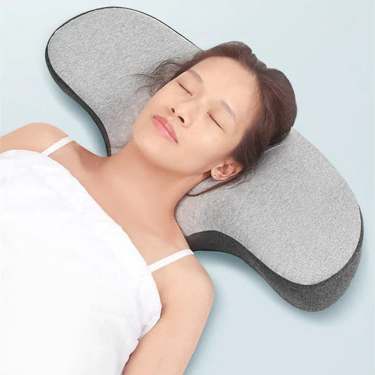 Cozy contoured memory foam pillow with gray cover, providing optimal neck support and comfort for a restful night's sleep.