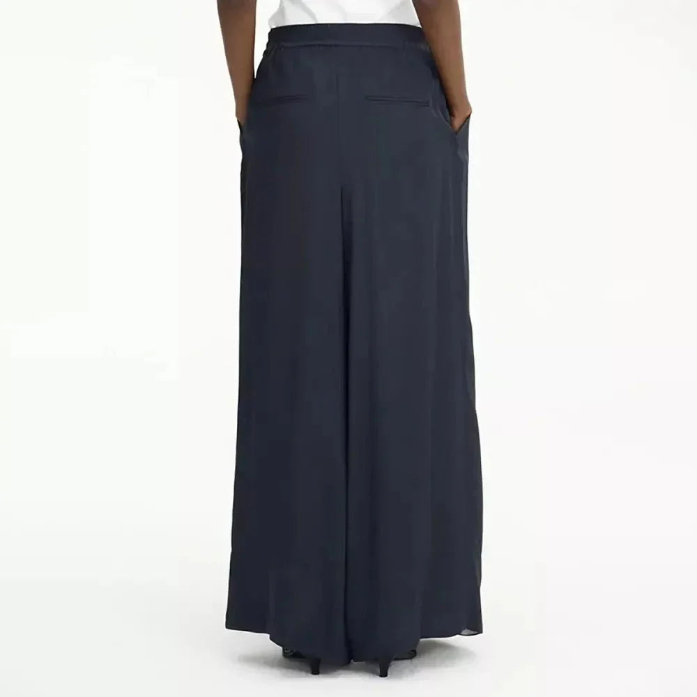 Chic navy high-waist wide-leg trousers with elegant patchwork design, offering timeless sophistication and modern style.