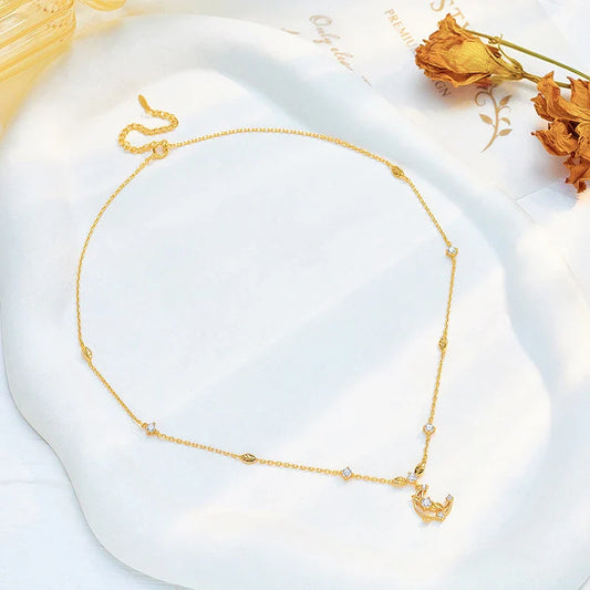 Elegant crescent moon necklace with intricate leaf design in a gleaming gold tone