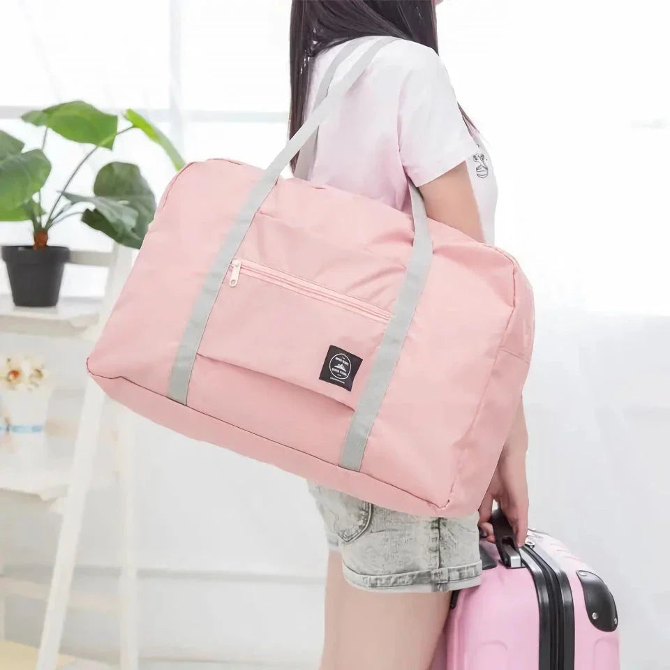 Premium foldable travel duffel bag in a solid colour design, with a large capacity and lightweight construction for women's travel needs.