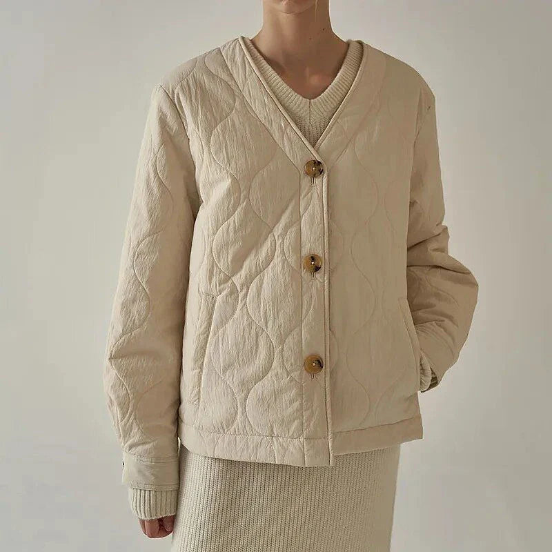 Women's black quilted jacket with button details, perfect for casual winter wear