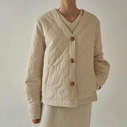 Women's black quilted jacket with button details, perfect for casual winter wear