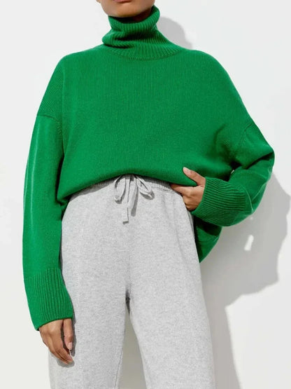 Cosy oversized knitted pullover in blue, featuring a classic turtleneck collar and drop-shoulder silhouette for maximum comfort and style.