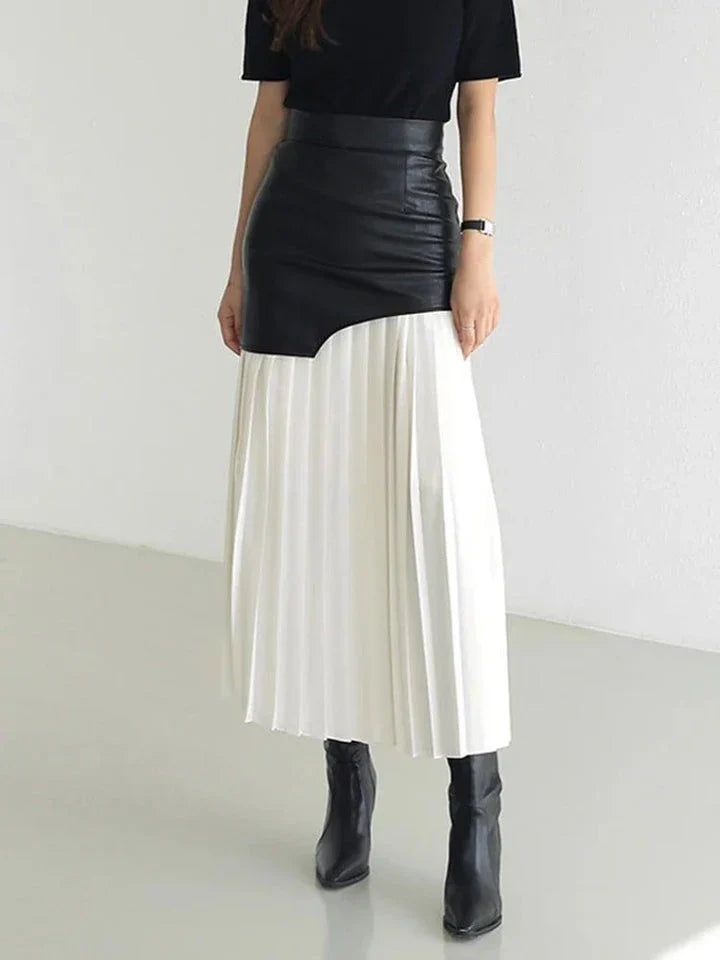 A stylish long pleated skirt featuring a sophisticated leather patchwork design and a flattering A-line silhouette
