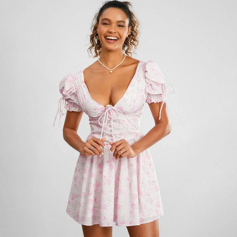 Floral mini dress with puff sleeves, featuring a V-neck, backless design, and A-line silhouette in a vibrant floral print