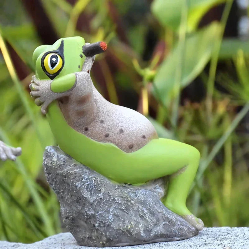 Charming resin frog garden ornaments in various poses and colours, perfect for adding a whimsical touch to outdoor spaces.