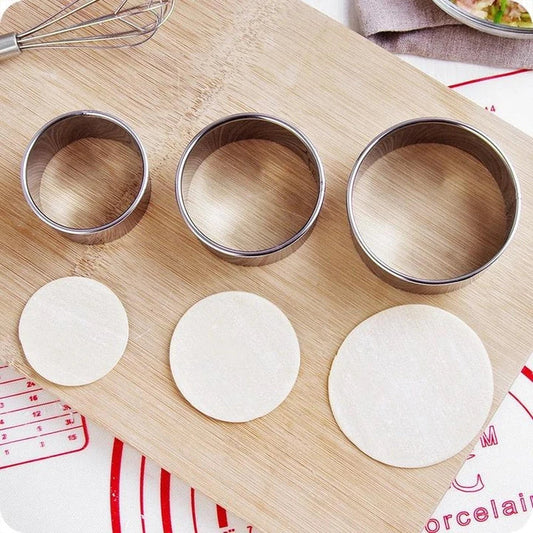 Premium stainless steel dumpling maker set with three distinct mold sizes for creating a variety of dumpling shapes