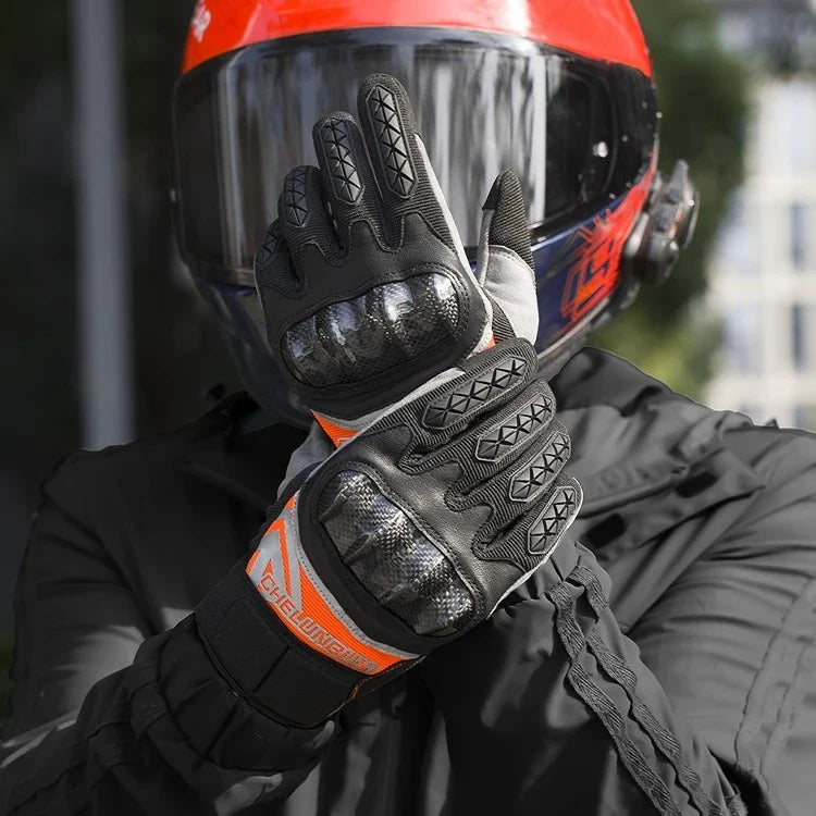 Pair of high-performance motorcycle riding gloves made from carbon fibre, featuring a sleek black design and reinforced palm and knuckle areas for superior protection.